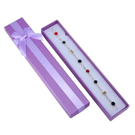 Metallic sheen bracelet card box with a satin ribbon bow and a White flock coated foam inner.
In assorted colours of Red, Blue, Light Pink, Gold, Lilac and Fuchsia.
Outer edge of box measures approx. 4cm x 21cm x 2cm.
Usable space 3.5cm x 20.5cm.
Pack