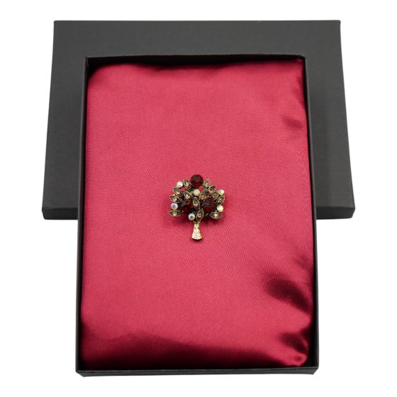 Ladies boxed gift set includes a satin square scarf and a tree design brooch with genuine crystal stones.
