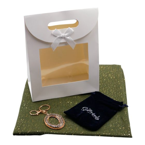 Ladies complete gift set includes a Gold colour foil speckle scarf, Gold colour plated bag charm with genuine Black diamond crystal stones, a Navy velvet drawstring gift pouch and a White card gift bag with a clear window and a velcro fastening.
