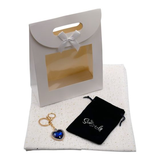 Ladies complete gift set includes a White/Gold colour foil speckle scarf, Gold colour plated heart bag charm with genuine Sapphire and Clear crystal stones, a Navy velvet drawstring gift pouch and a White card gift bag with a clear window and a velcro fas