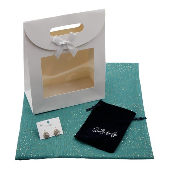 Ladies complete gift set includes a Teal/Gold colour foil speckle scarf, Gold colour plated pierced stud earrings with genuine Clear crystal stones, a Navy velvet drawstring gift pouch and a White card gift bag with a clear window and a velcro fastening.
